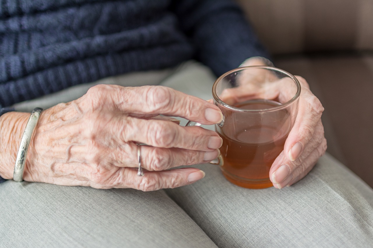 An elderly person cradles a cup of tea. University of Reading research is informing the management of cancer care in elderly people, changing practice and medical education.